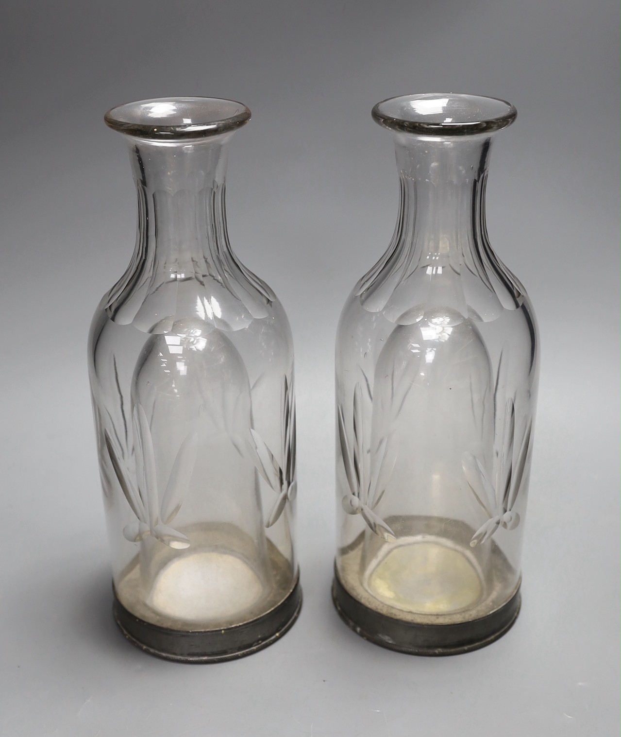 A pair of French glass carafes with silver plated bases and integral ice compartment 28cm